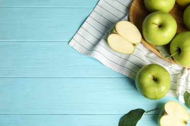 Photo of Flat lay composition of fresh ripe green apples on blue wooden table, space for text