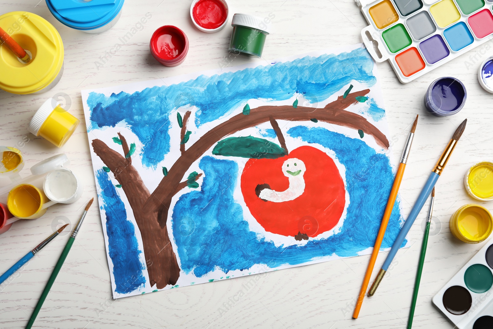 Photo of Flat lay composition with child's painting of apple tree with worm on white wooden table
