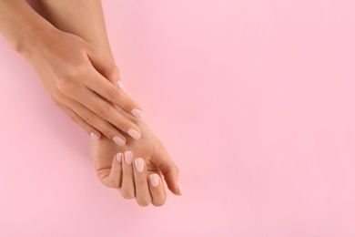 Closeup view of woman with beautiful hands on color background, space for text. Spa treatment
