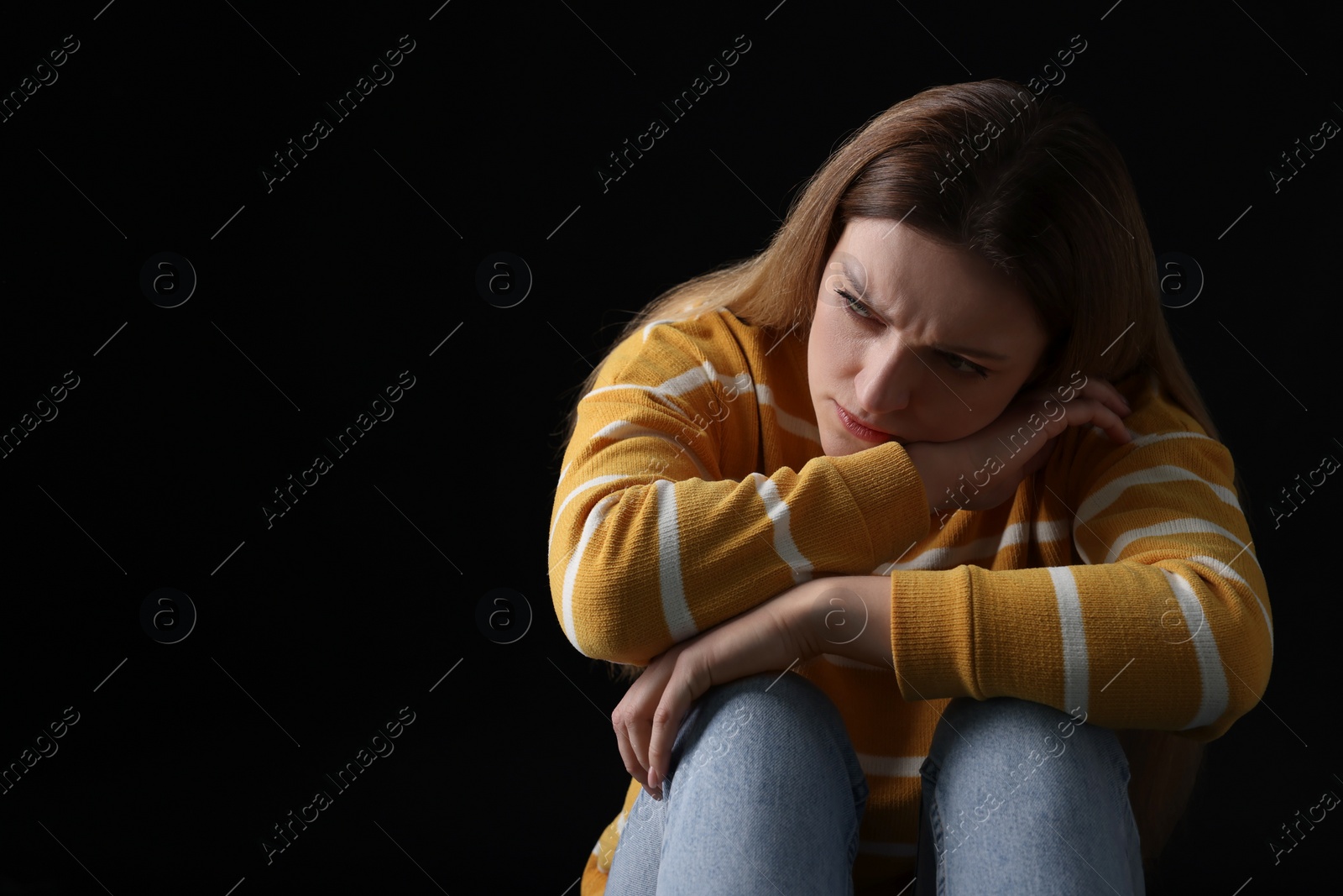Photo of Portrait of sad woman on black background, space for text
