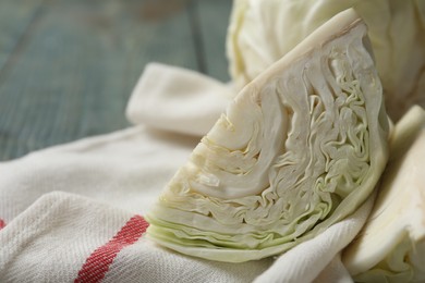 Photo of Fresh cut cabbage on table, closeup view
