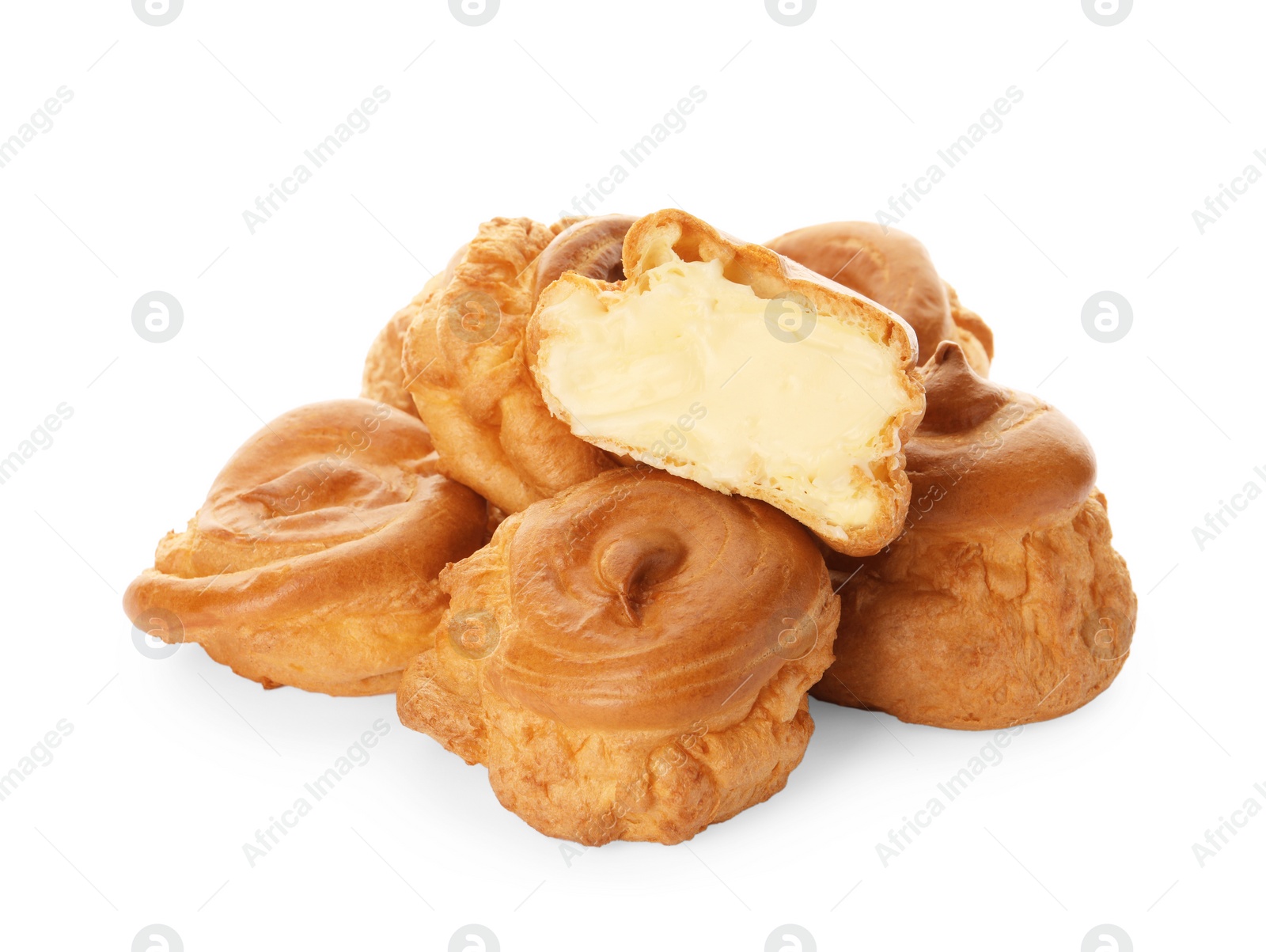 Photo of Cut and whole delicious profiteroles with cream filling on white background