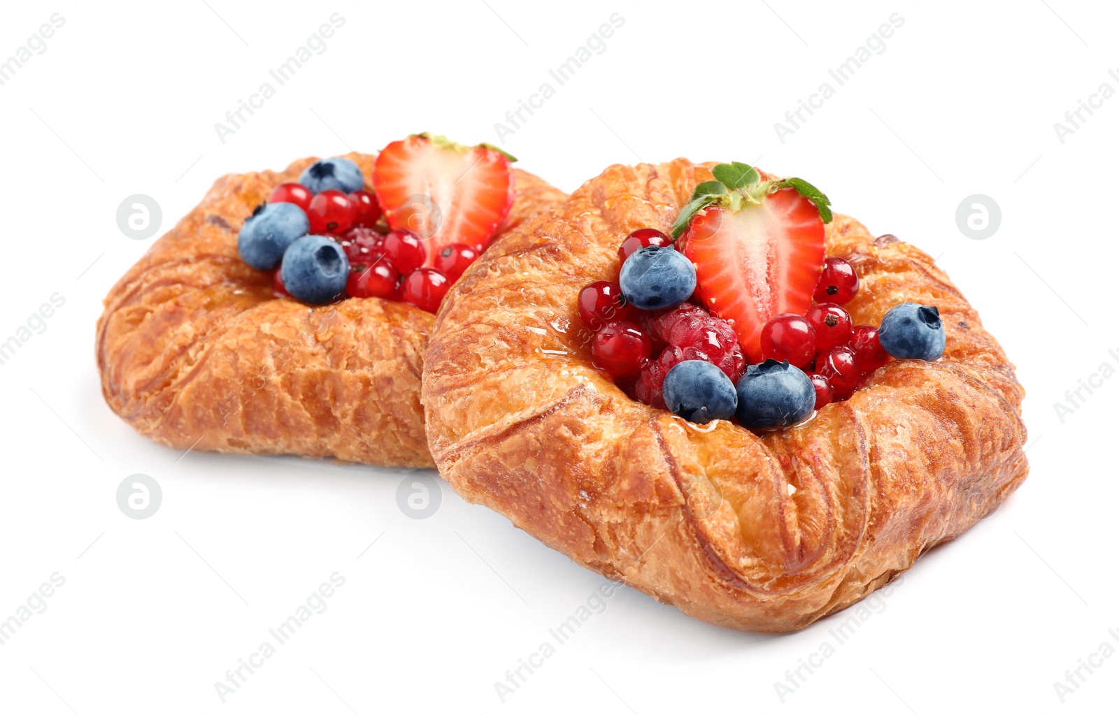 Photo of Fresh delicious puff pastry with sweet berries on white background