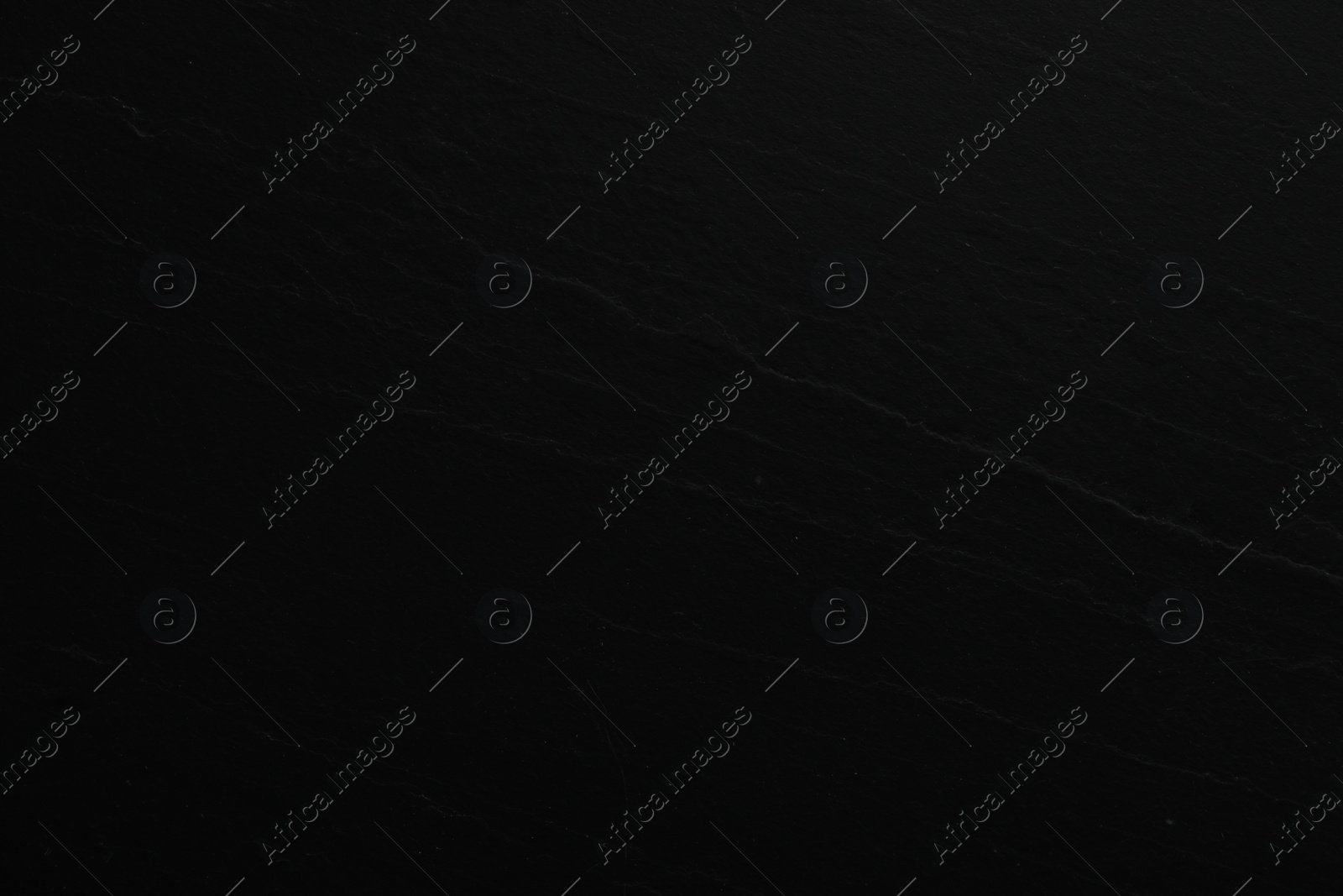 Photo of Texture of black stone surface as background, closeup