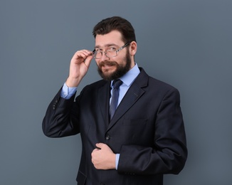 Photo of Portrait of confident mature man in elegant suit on color background