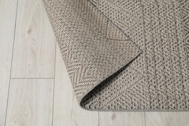 Photo of Soft grey carpet on white laminated floor indoors, top view