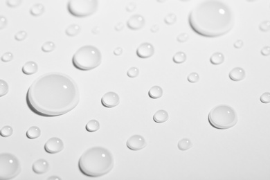 Photo of Pure water drops on white background, closeup