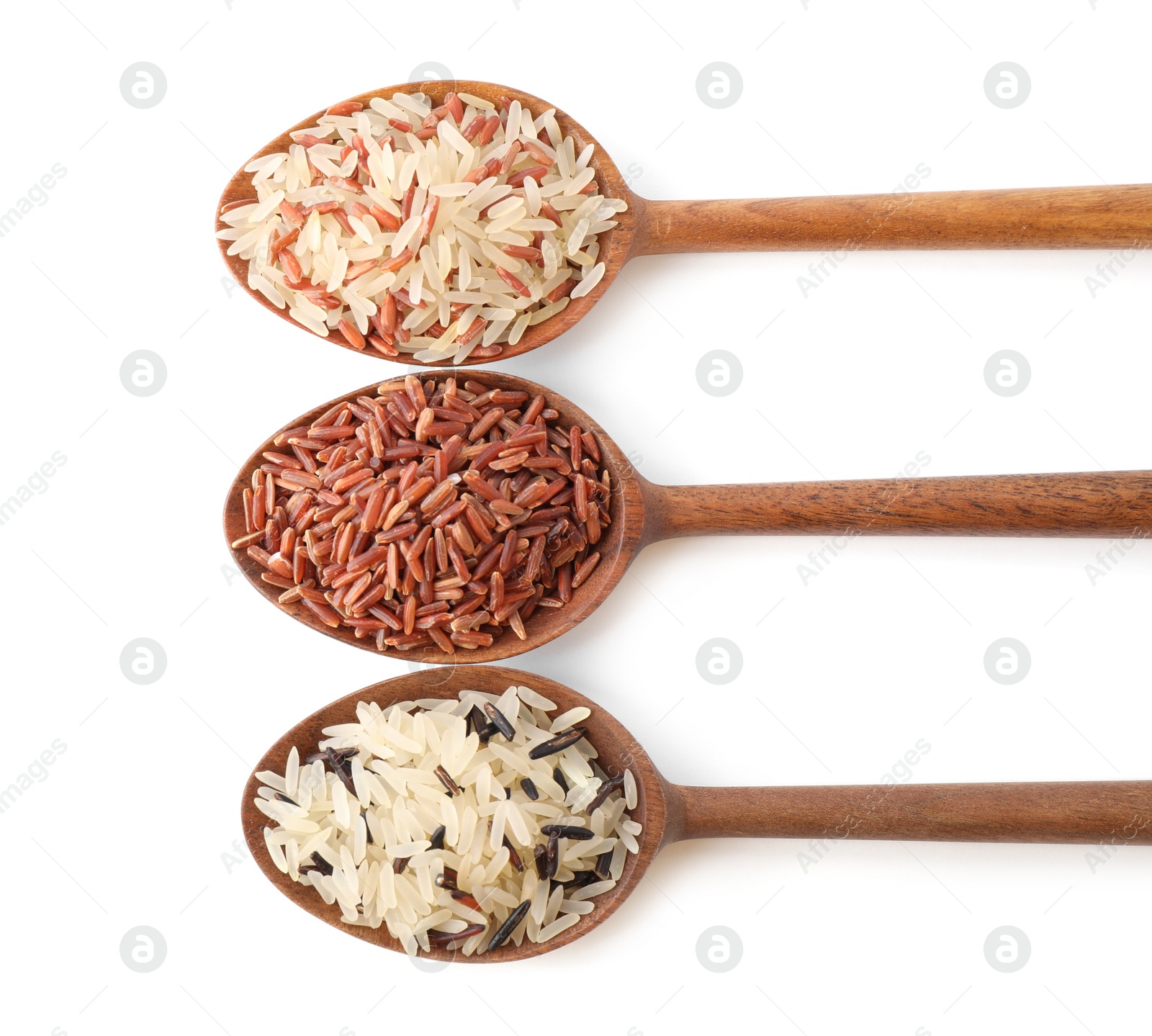 Photo of Brown and polished rice in spoons isolated on white, top view