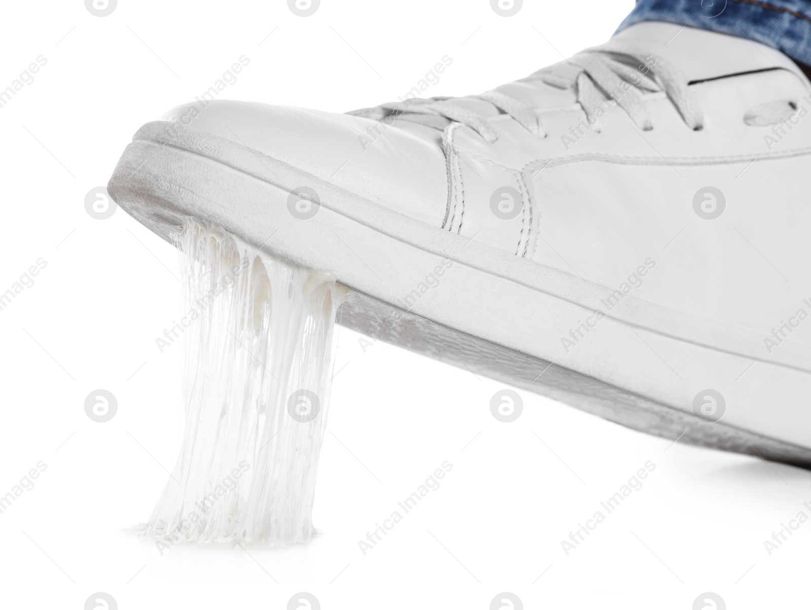 Photo of Person stepping into chewing gum on white background, closeup