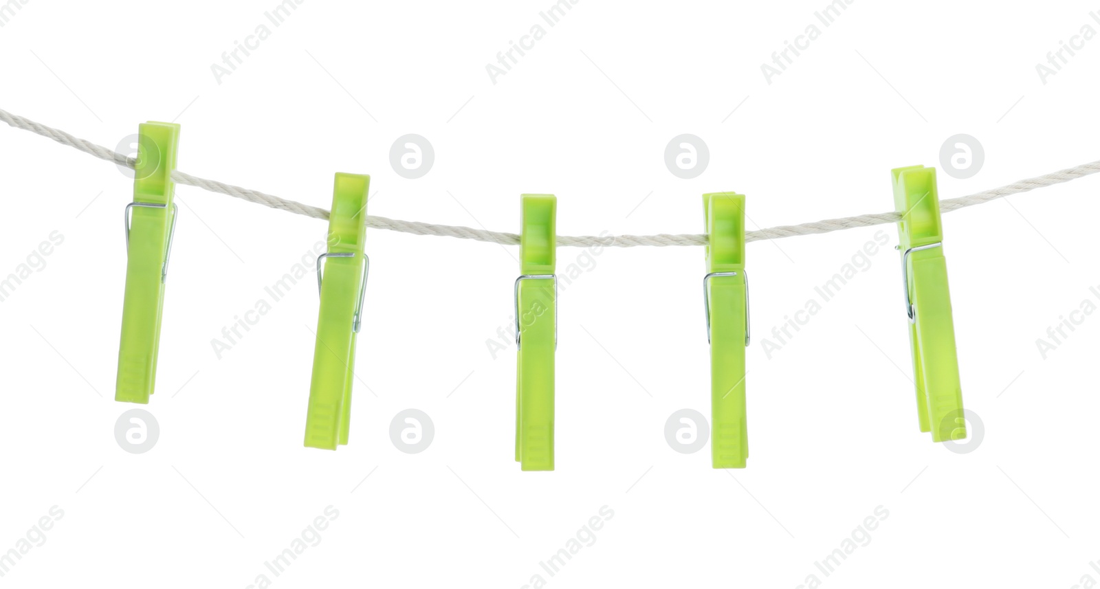 Photo of Bright green plastic clothespins hanging on rope against white background