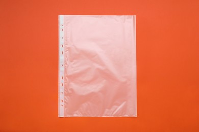 Photo of Punched pocket on orange background, top view