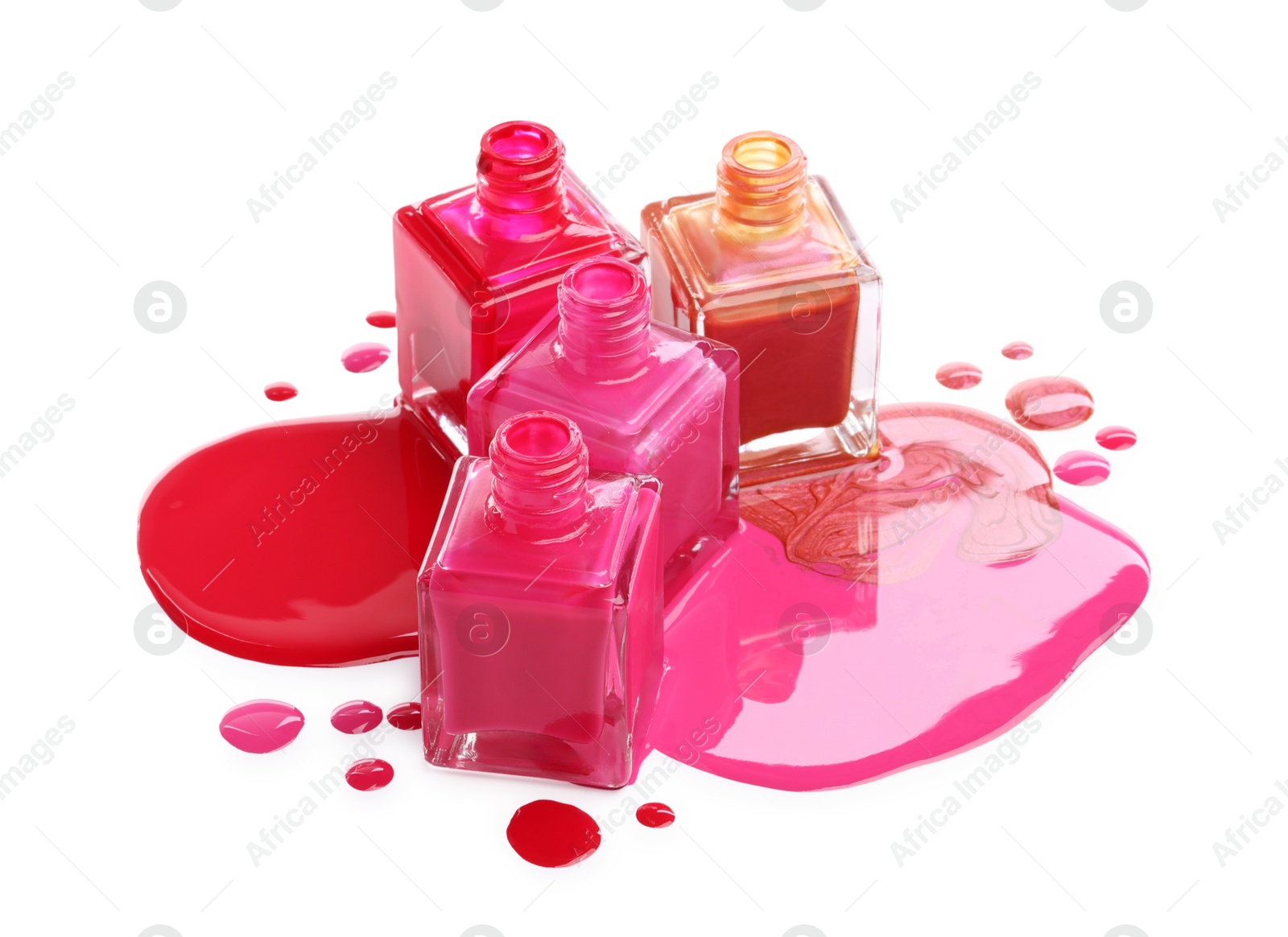 Photo of Different bright nail polishes and bottles isolated on white