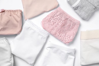Photo of Stylish folded women's underwear on white background, flat lay