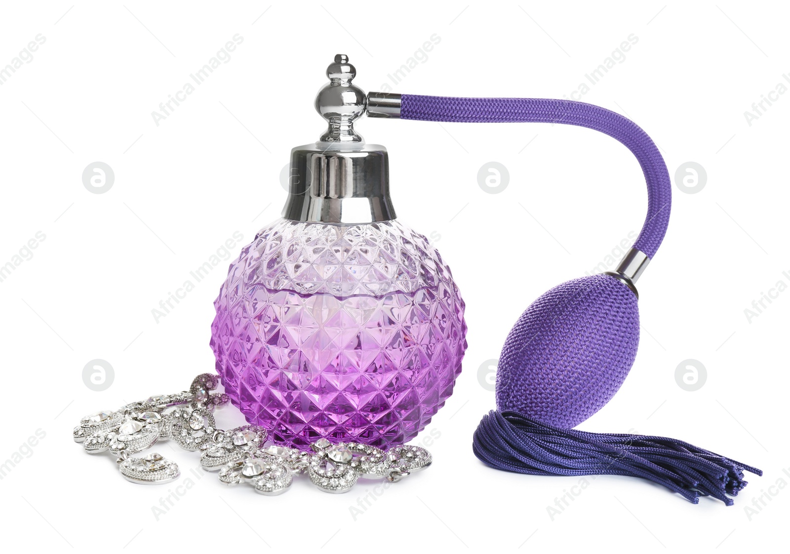 Photo of Glass bottle of perfume and luxury jewellery isolated on white