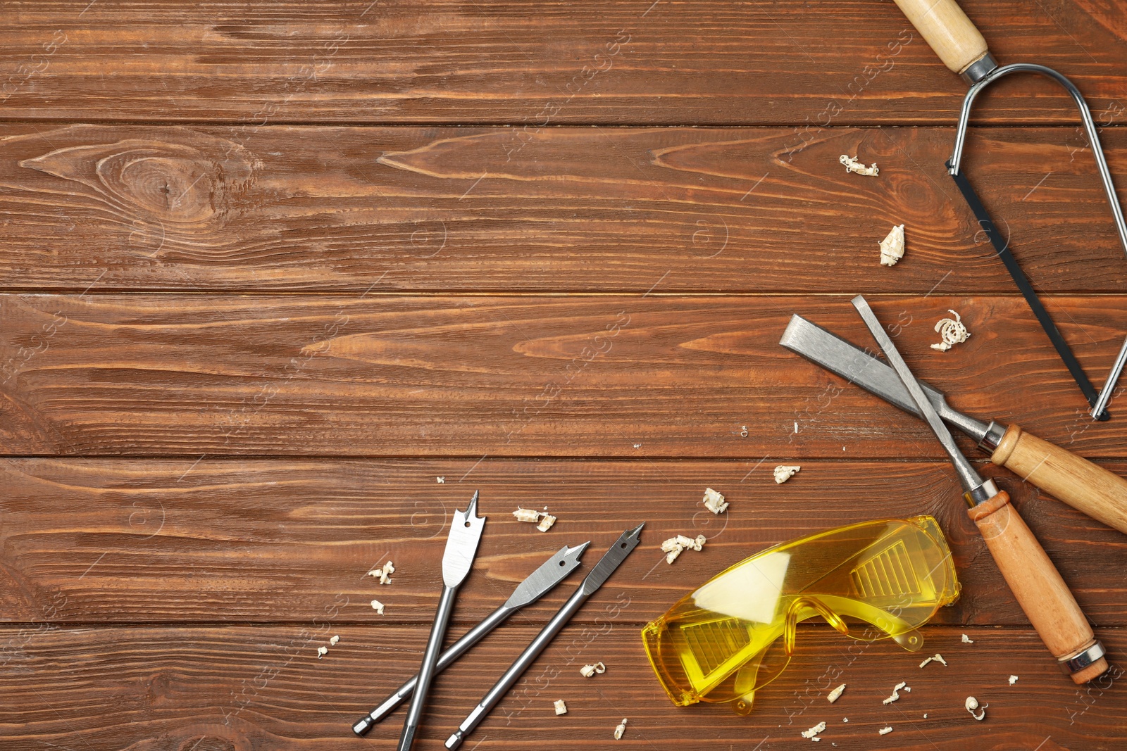 Photo of Flat lay composition with carpenter's tools on wooden background. Space for text