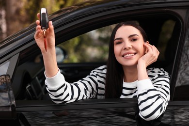 Photo of Woman holding car flip key inside her vehicle