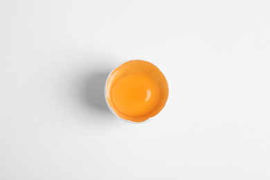 Photo of Broken raw chicken egg on white background, top view