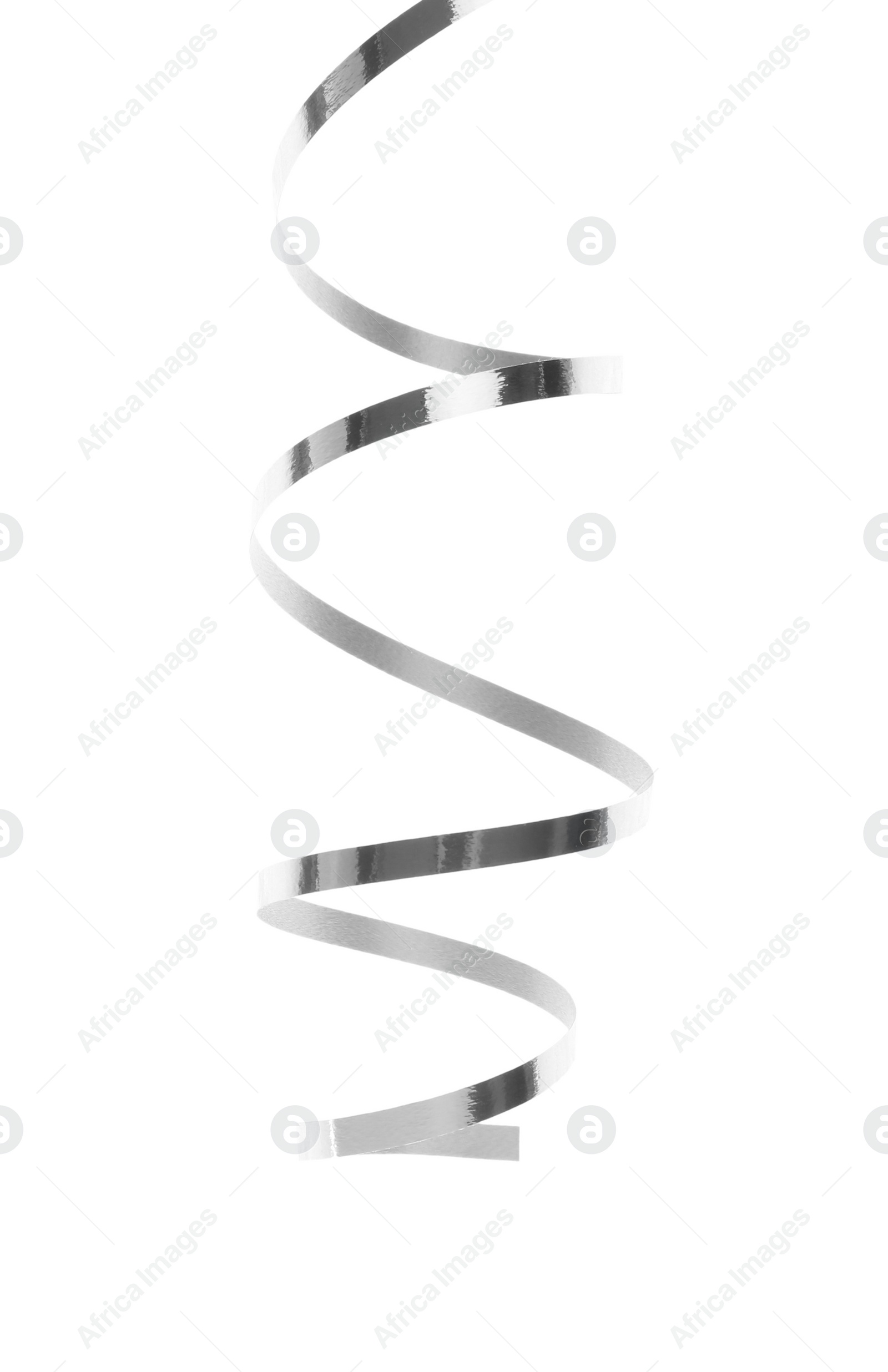 Photo of Shiny serpentine streamer on white background. Festive decor