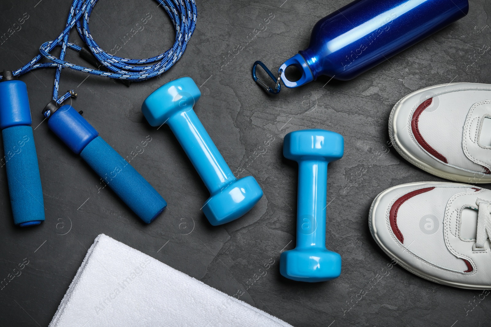 Gym equipment on black background, flat lay Photo of Gym equipment on black background, flat lay