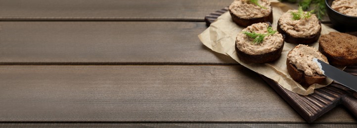 Image of Slices of bread with delicious pate served on wooden table, space for text. Banner design