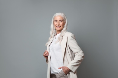 Photo of Portrait of beautiful mature woman on grey background