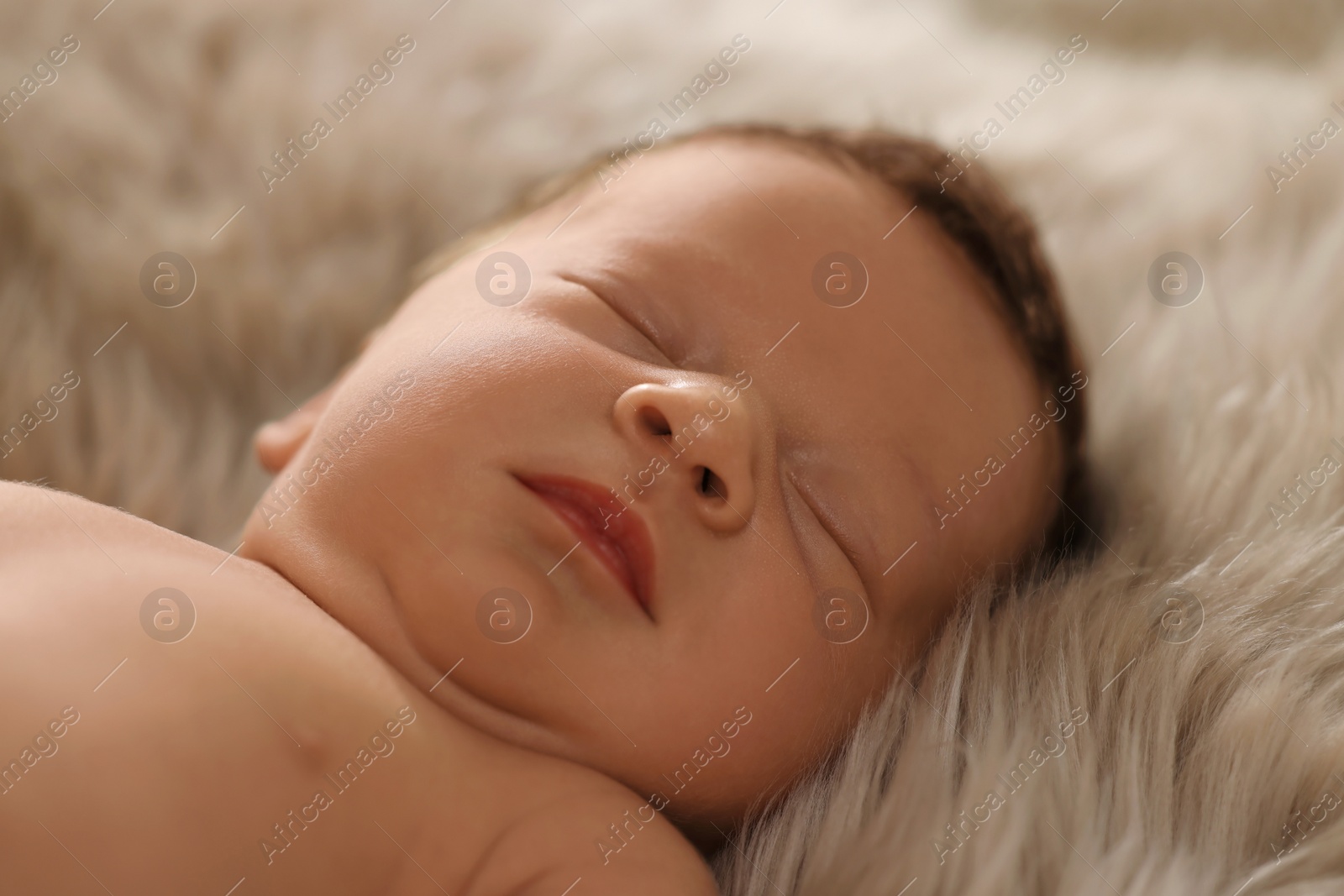 Photo of Cute newborn baby sleeping on fluffy blanket, closeup