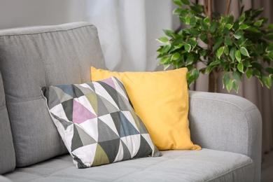 Photo of Comfortable sofa with pillows in living room