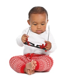 Cute African-American baby with funny glasses on white background. First Christmas