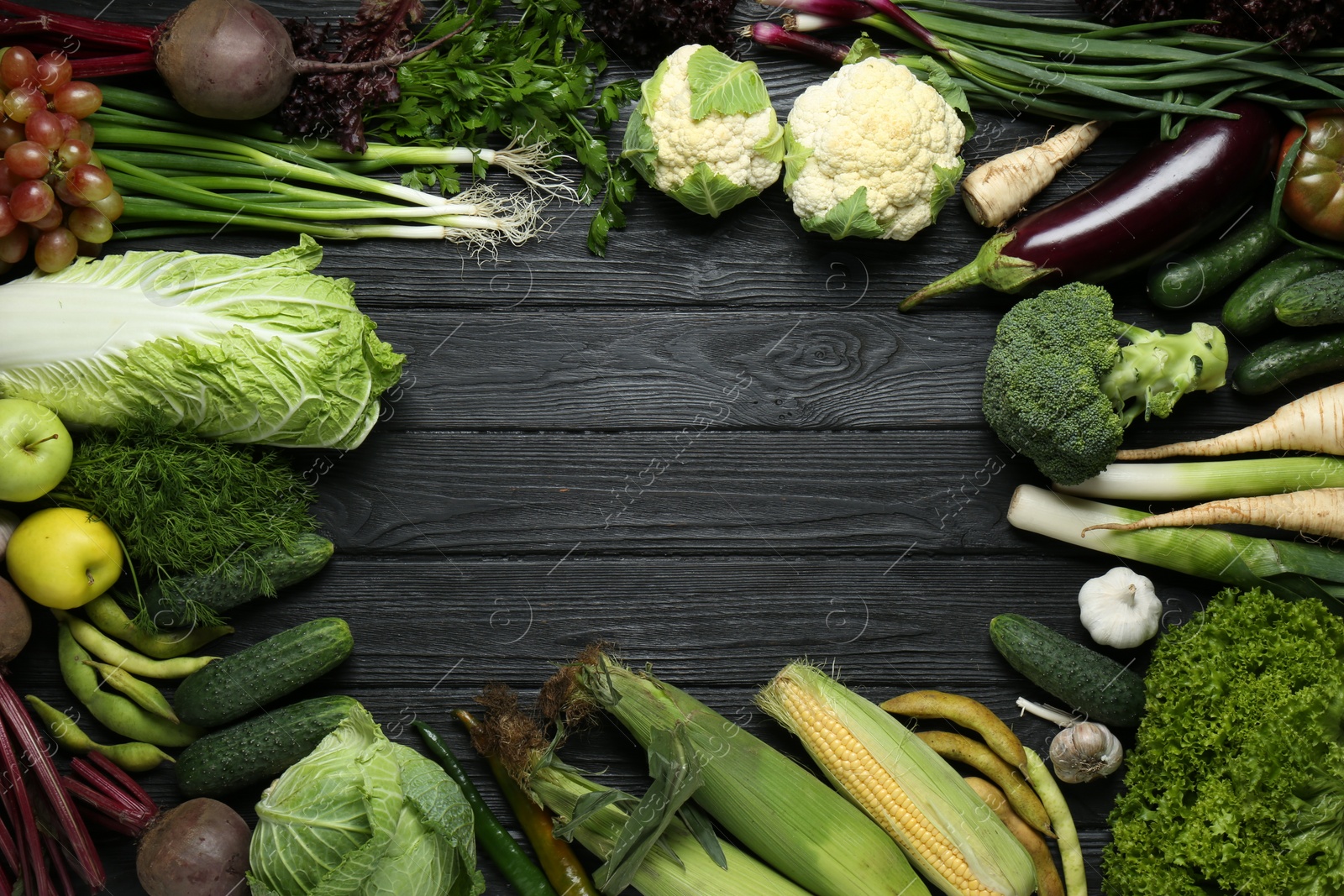 Photo of Frame made of different fresh ripe vegetables and fruits on black wooden table, flat lay with space for text. Farmer produce