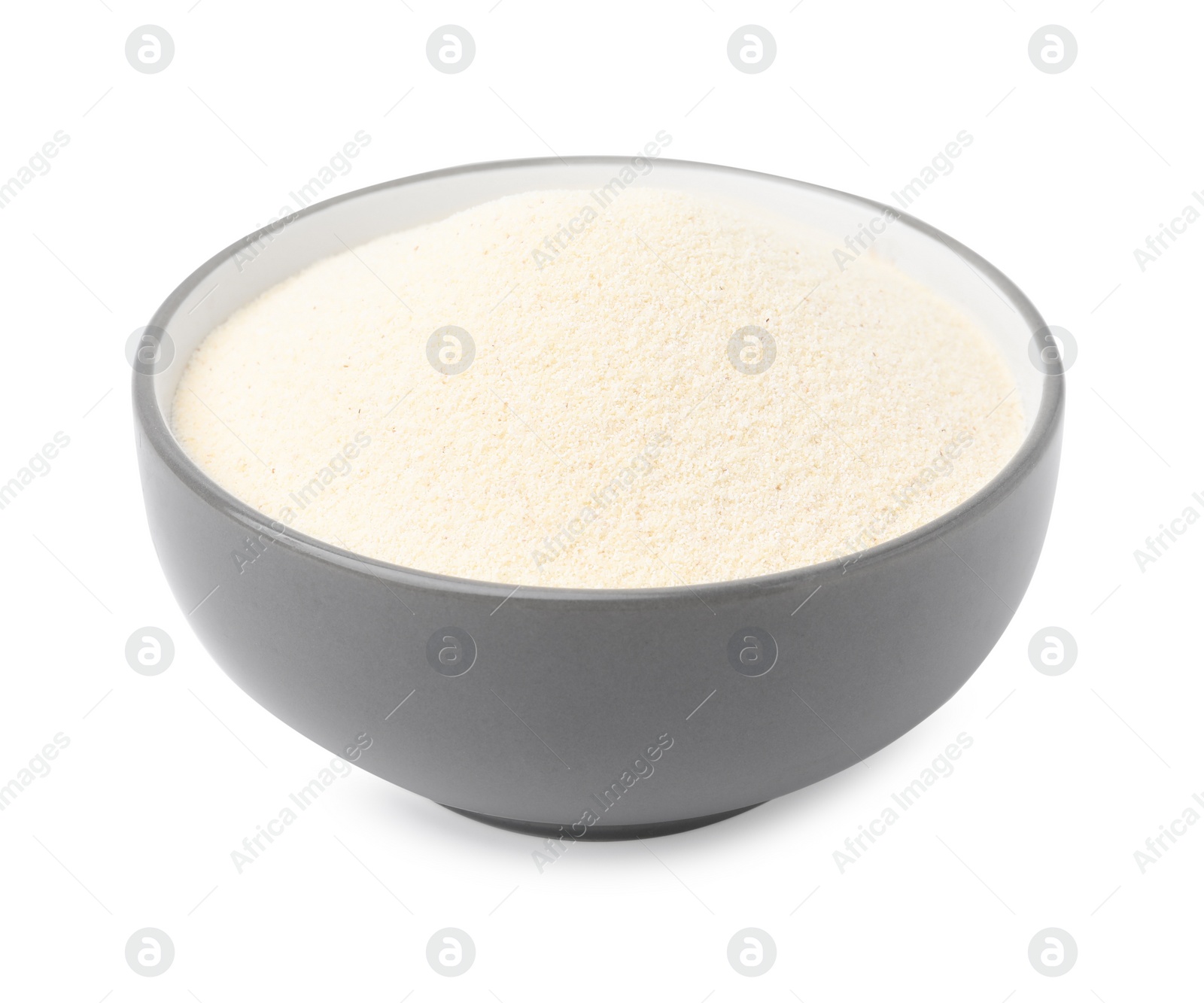 Photo of Bowl of uncooked organic semolina isolated on white