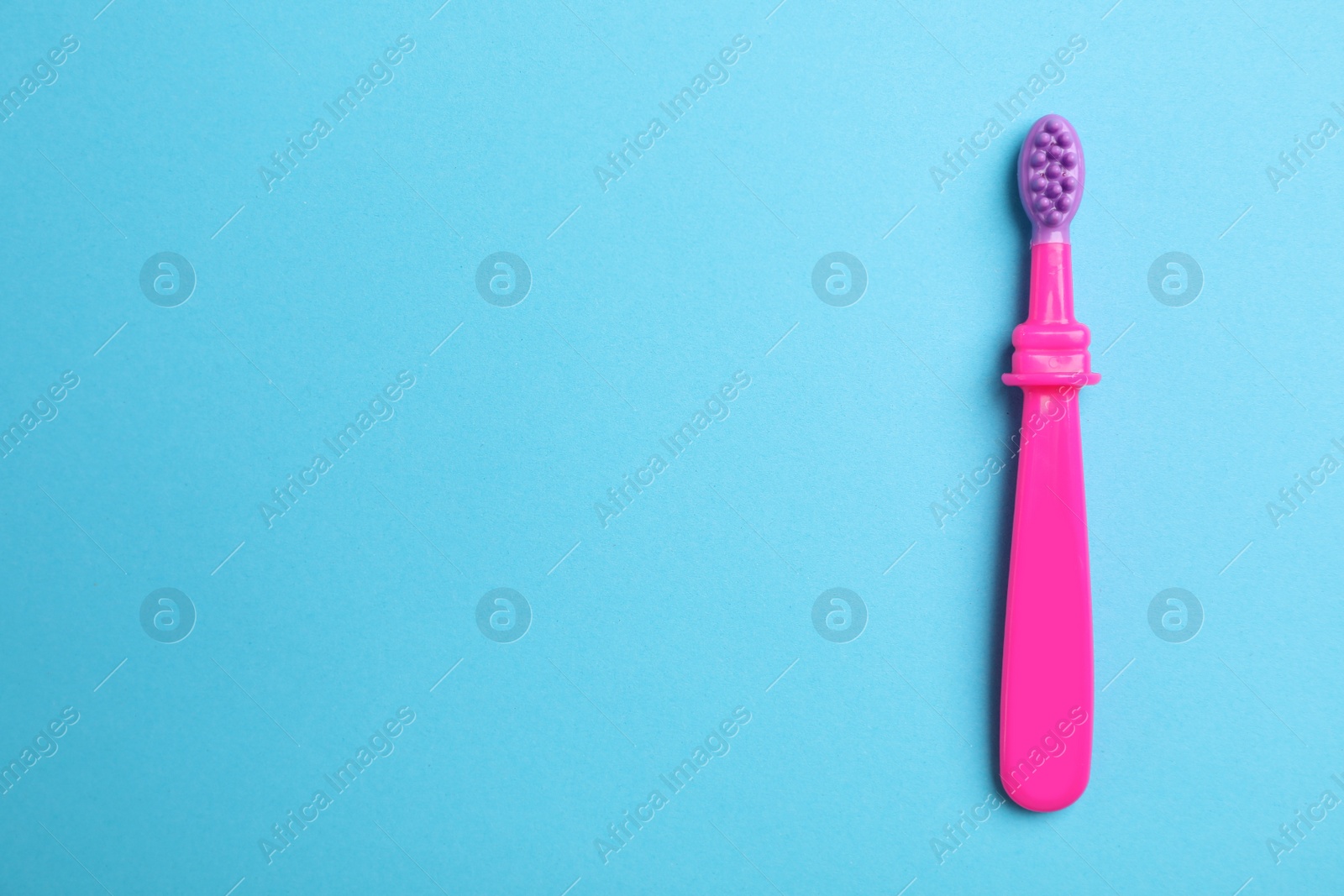 Photo of Manual toothbrush for child on color background, top view with space for text