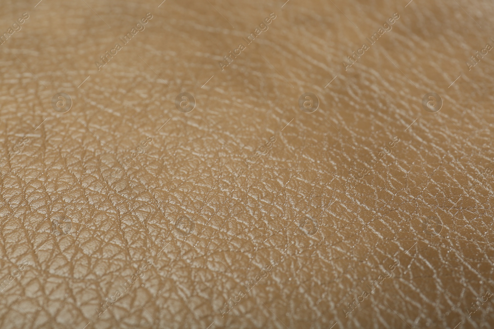 Photo of Texture of beige leather as background, closeup