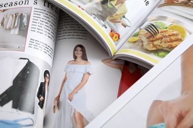 Variety of women's modern magazines, closeup view