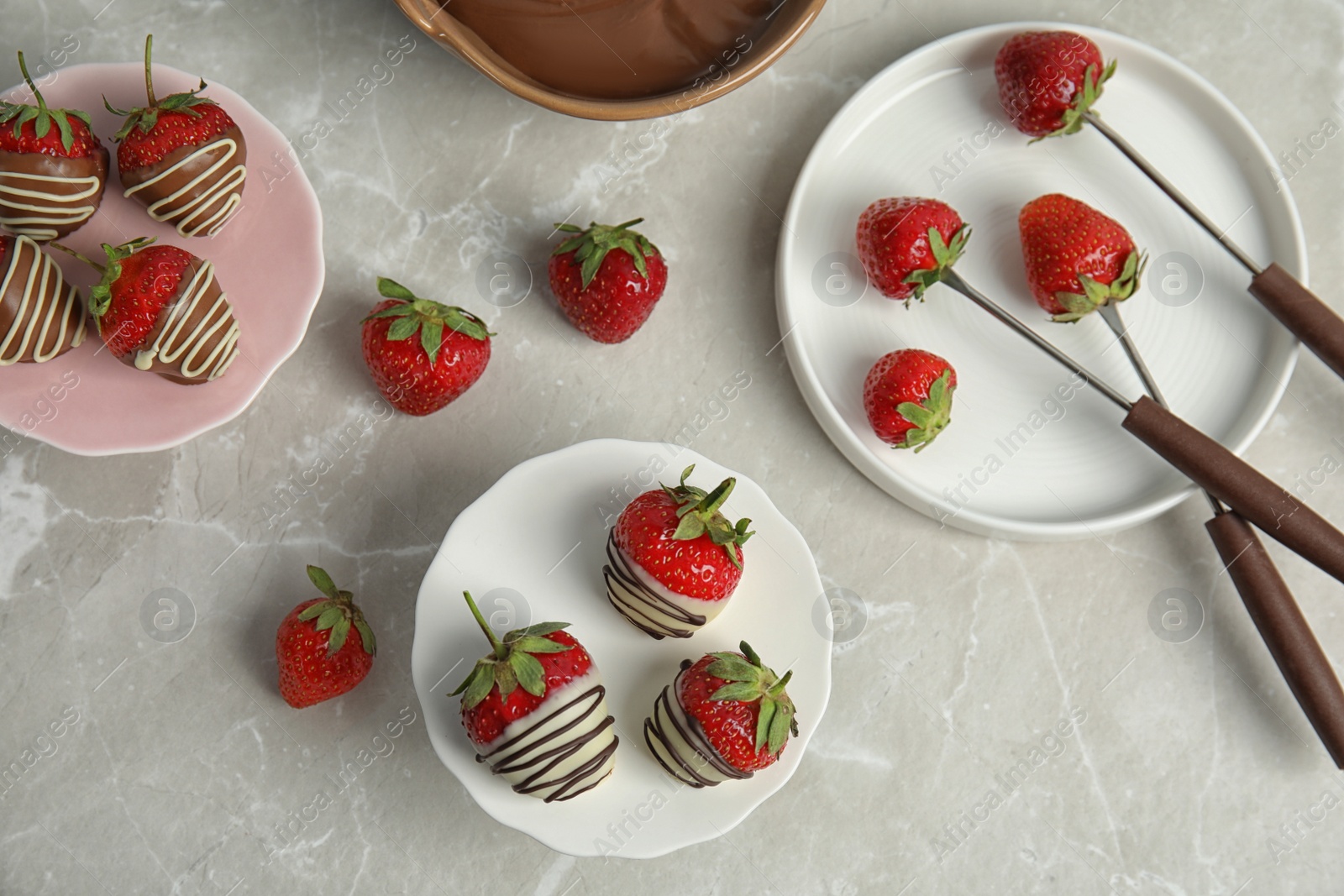 Photo of Flat lay composition with chocolate covered strawberries on grey background