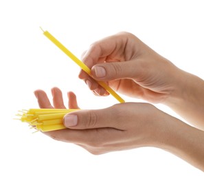 Woman holding church candles on white background, closeup