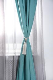 Photo of Window curtains with tassel tieback in room