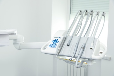 Photo of Set of professional equipment in dentist's office. Space for text