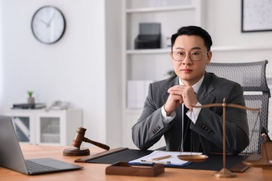 Notary working at wooden table in office, space for text