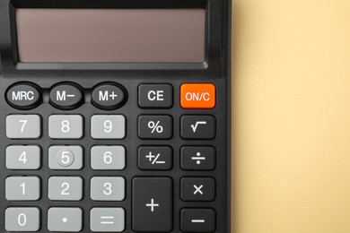 Photo of Calculator on beige background, top view. Office equipment