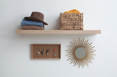 Photo of Shelf with clothes and accessories in hallway