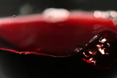 Photo of Delicious red wine in glass as background, closeup