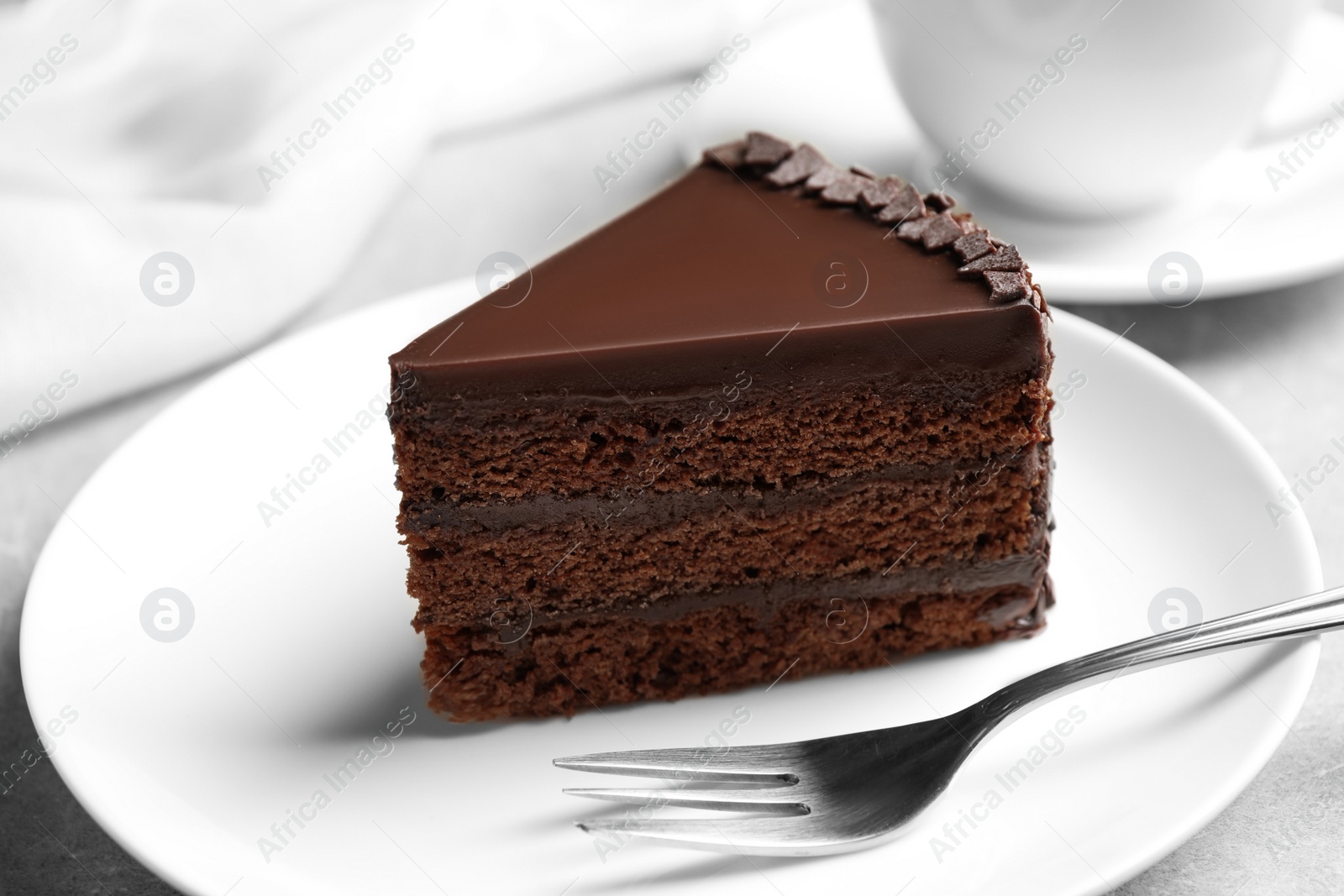 Photo of Piece of tasty chocolate cake served on plate