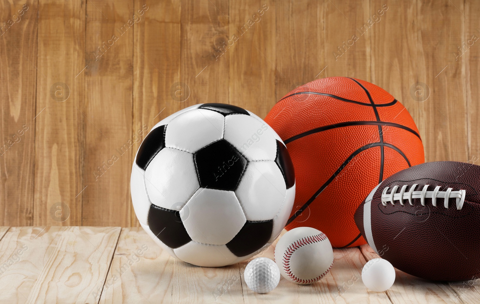 Photo of Many different sports balls on wooden background, space for text