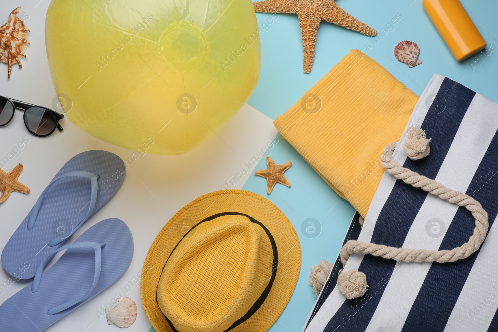 Photo of Flat lay composition with beach ball and other accessories on color background