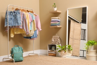 Stylish dressing room interior with trendy clothes