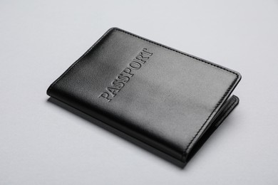 Photo of Passport in black leather case on light grey background