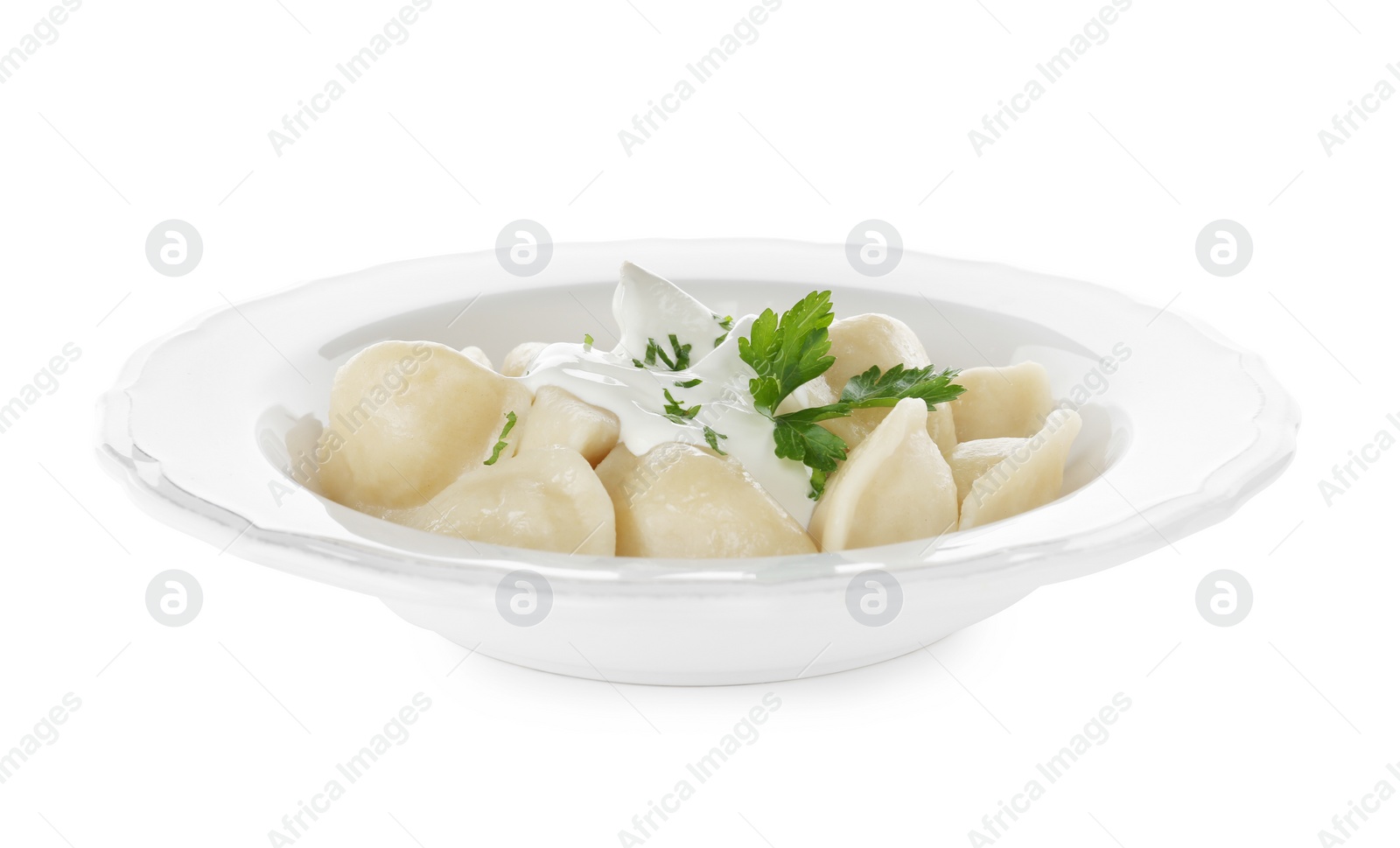 Photo of Delicious cooked dumplings with sour cream on white background