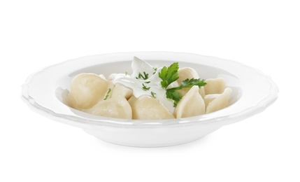 Photo of Delicious cooked dumplings with sour cream on white background