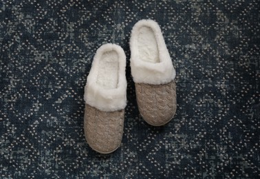Photo of Pair of beautiful soft slippers on carpet, top view