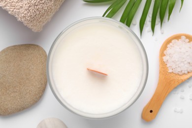 Photo of Flat lay composition with candle and different spa products on white background